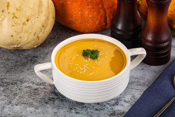 Vegan pumpkin cream soup served sesam