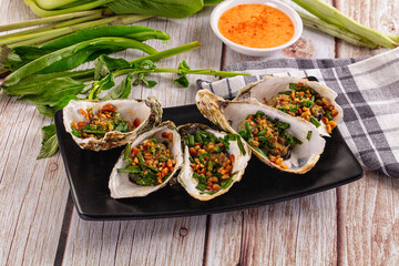 Gournet grilled oysters with onion and peanut