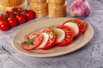 Italian caprese salad with mozzarella, tomato and basil
