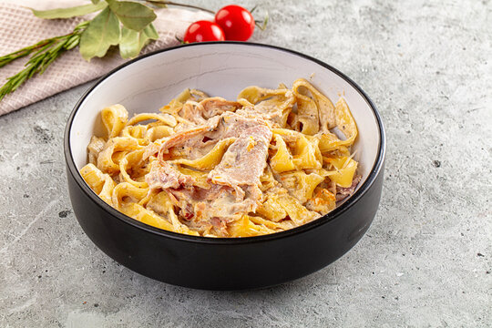 Italian pasta fettuccine with prosciutto