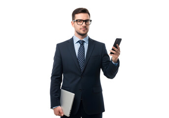 Serious professional businessman in a navy suit holding a smartphone and laptop, looking at the camera against a white background.