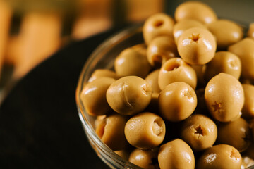 Fresh green olives in a glass bowl ready for a tasty snack or cooking ingredient