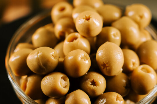 Fresh green olives displayed in a clear bowl ready for tasting or cooking