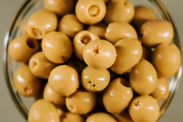 Fresh olives in a clear bowl ready for tasting at a local market in midday