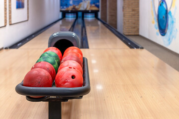 Bowling center with lanes and colorful bowling balls. Entertainment center. Board game