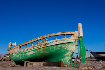 old abandoned wooden boat on the beach, an old shipwreck boat abandoned stand on beach or Shipwrecked off the coast of El Alquian, Almeria, Andalusia, Spain, old rusty wooden boat