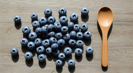 Fresh blueberries and wooden spoon on rustic table