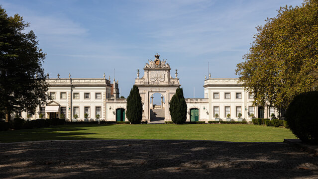 Palácio de Seteais in Sintra, Portugal with neoclassical architecture, manicured gardens, and iconic triumphal arch under a clear blue sky
