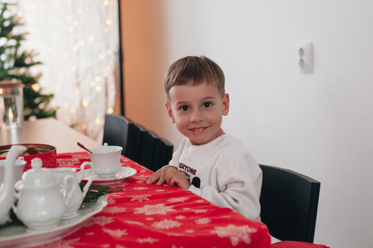 A baby eats a gingerbread cookie in the kitchen