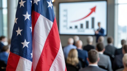 Business conference with American flag in foreground and presentation about economic growth in background.
