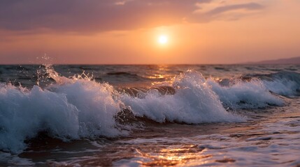 Dramatic sunset over the ocean with powerful waves crashing onto the shore casting golden light