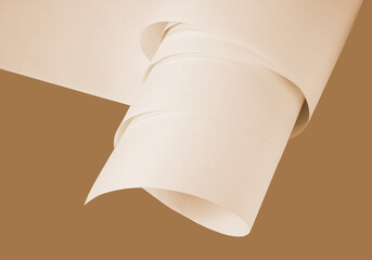 Long sheets of paper from a roll in a warm ochre tone.