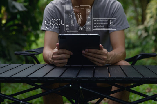 Person Using Tablet in Nature with Health and Care Technology Overlay