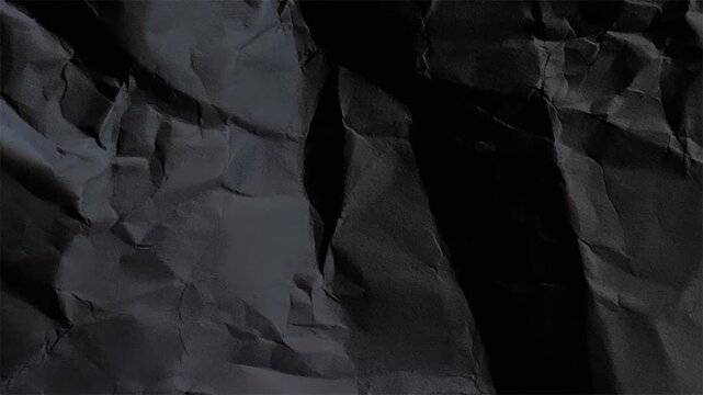 Dark paper texture background seamless loop, grunge folded surface with wrinkles and shadows. Crumpled black paper backdrop creating vintage, rough texture for creative layouts and overlays