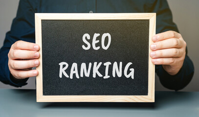 Board with words SEO ranking. Position a website or webpage holds in the search engine results...