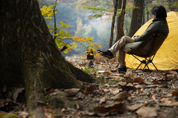 秋のソロキャンプ を楽しむ男性