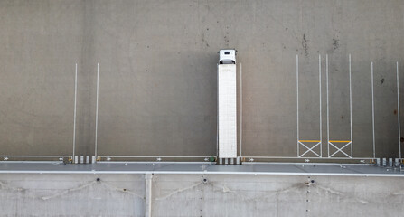 Aerial view of a semi-truck parked in a loading dock area, ready for loading and unloading.
