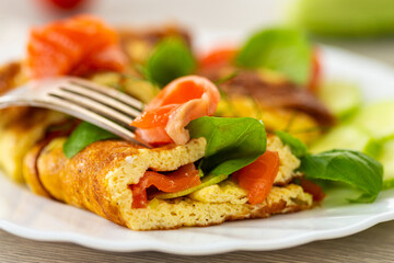 Omelet with red fish and fresh herbs