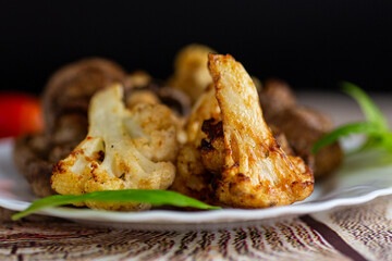 Delicious baked cauliflower and mushrooms with fresh basil garnish