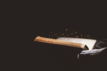 Open Bible glowing with golden light, symbolizing the Word of God, faith, prayer, hope, spiritual guidance, Christianity, holy scripture, wisdom, divine inspiration and eternal truth.