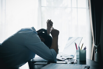Stressed businesswoman working late at home office, feeling exhausted while reviewing financial documents on laptop. Concept of work stress, burnout, deadline and overwork.
