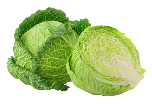 Fresh green cabbage, one whole and one halved, on black