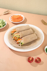 Healthy Buckwheat Vegetable Wraps with Fresh Ingredients on Wooden Table