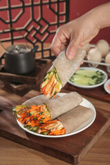 Healthy Buckwheat Burrito Production with Fresh Vegetable Ingredients on Wooden Board