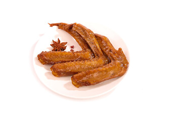 Five Spicy Marinated Duck Wings Baked with Star Anise and Salt on White Plate