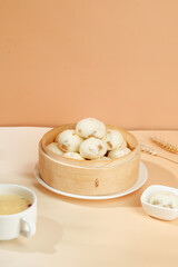Traditional Chinese Xiaolongbao Steamed Dumplings in Bamboo Steamer with Tea - Asian Cuisine