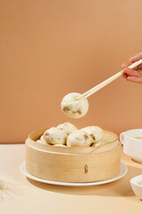Traditional Xiao Long Bao Dumplings with Plum Vegetable Filling in Bamboo Steamer - Shengzhou Cuisine