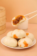 Traditional Chinese Xiao Long Bao Dumplings with Chopsticks and Bamboo Steamer Shengzhou Style