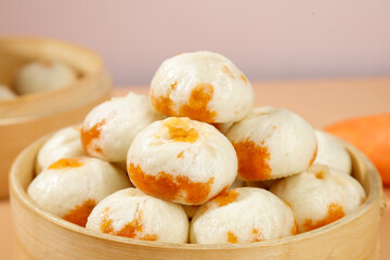 Traditional Chinese Steamed Buns Bao with Orange Filling in Bamboo Steamer - Shengzhou Xiao Long...