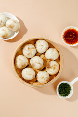 Fresh Shengzhou Xiaolongbao Traditional Chinese Soup Dumplings in Bamboo Steamer with Meat Filling and Dipping Sauce