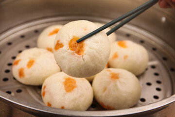 Traditional Chinese Steamed Buns Baozi with Chopsticks in Bamboo Steamer - Authentic Asian Dim Sum Cuisine