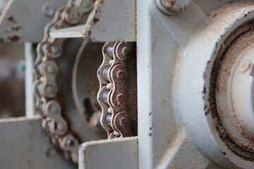 Metal parts of a woodworking machine in close-up. An iron chain. The concept of woodworking.