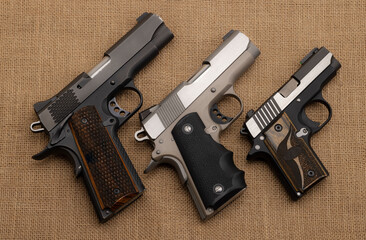 Semi automatic handguns on  burlap background , 1911 the same of Single Action