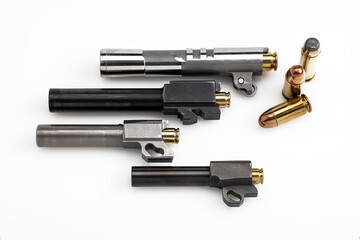 Difference size of automatic hand gun barrel with bullets on white background