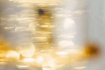 Golden bokeh lights celebrating the joyful spirit of Christmas season at a cozy indoor setting