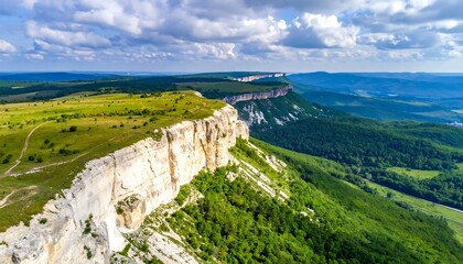 Aerial view of a stunning mountain landscape under a cloudy sky.