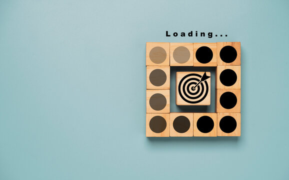 Black dartboard with arrow print screen on circle wooden block with loading for setup business objective target progressive concept.