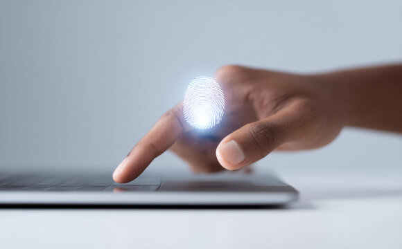 Secure access with glowing fingerprint scan. focused person uses biometric technology on laptop for digital identity authentication, ensuring modern cybersecurity and protection