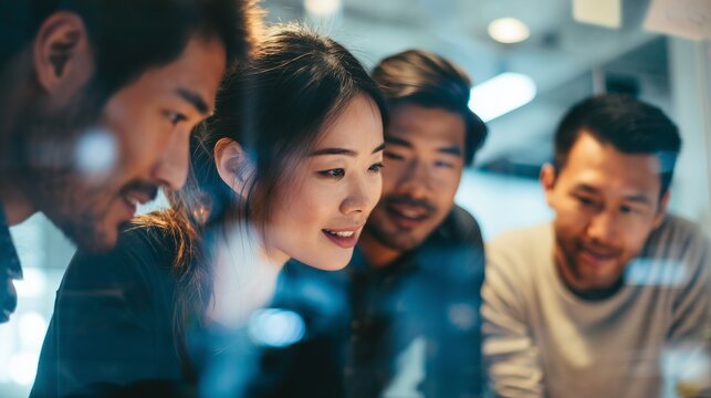 A group of young professionals engages in a collaborative discussion, focusing intently on their innovative project ideas. The energetic atmosphere encourages teamwork and creativi