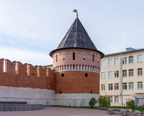 The powerful Na'ugolnaya (Corner) Tower of the Tula Kremlin, made of red brick and white stone, against a clear sky. A majestic monument of ancient Russian defensive architecture.