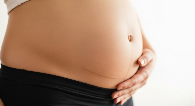 Pregnant woman holding belly pregnancy health motherhood expecting baby prenatal care maternity wellness