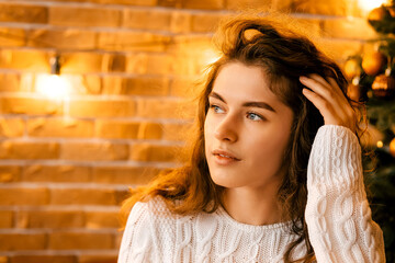 cozy room decorated for the new year and christmas. brick wall with retro lamps, loft style