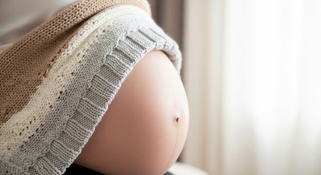 Pregnancy belly close up with soft blanket expectant mother maternity photoshoot pregnancy announcement concept