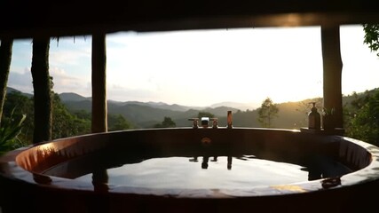 Relaxing soak in a mountain view bathtub at sunset retreat