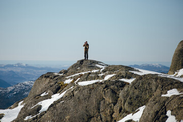 Photographer on Snowy Mountain Peak