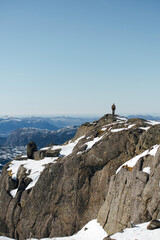 Lone Hiker on Snowy Mountain Peak